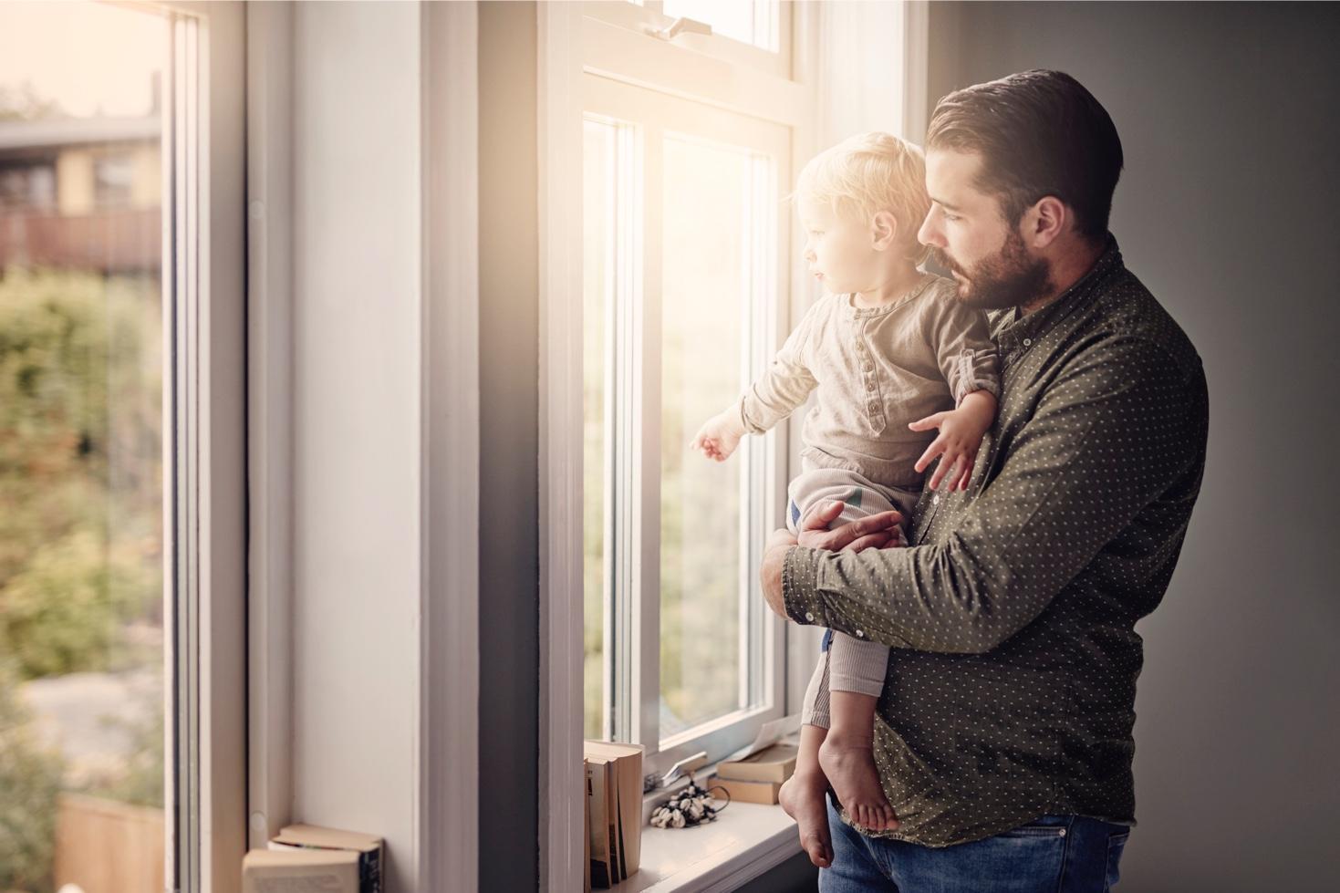 Father with child looking out of window