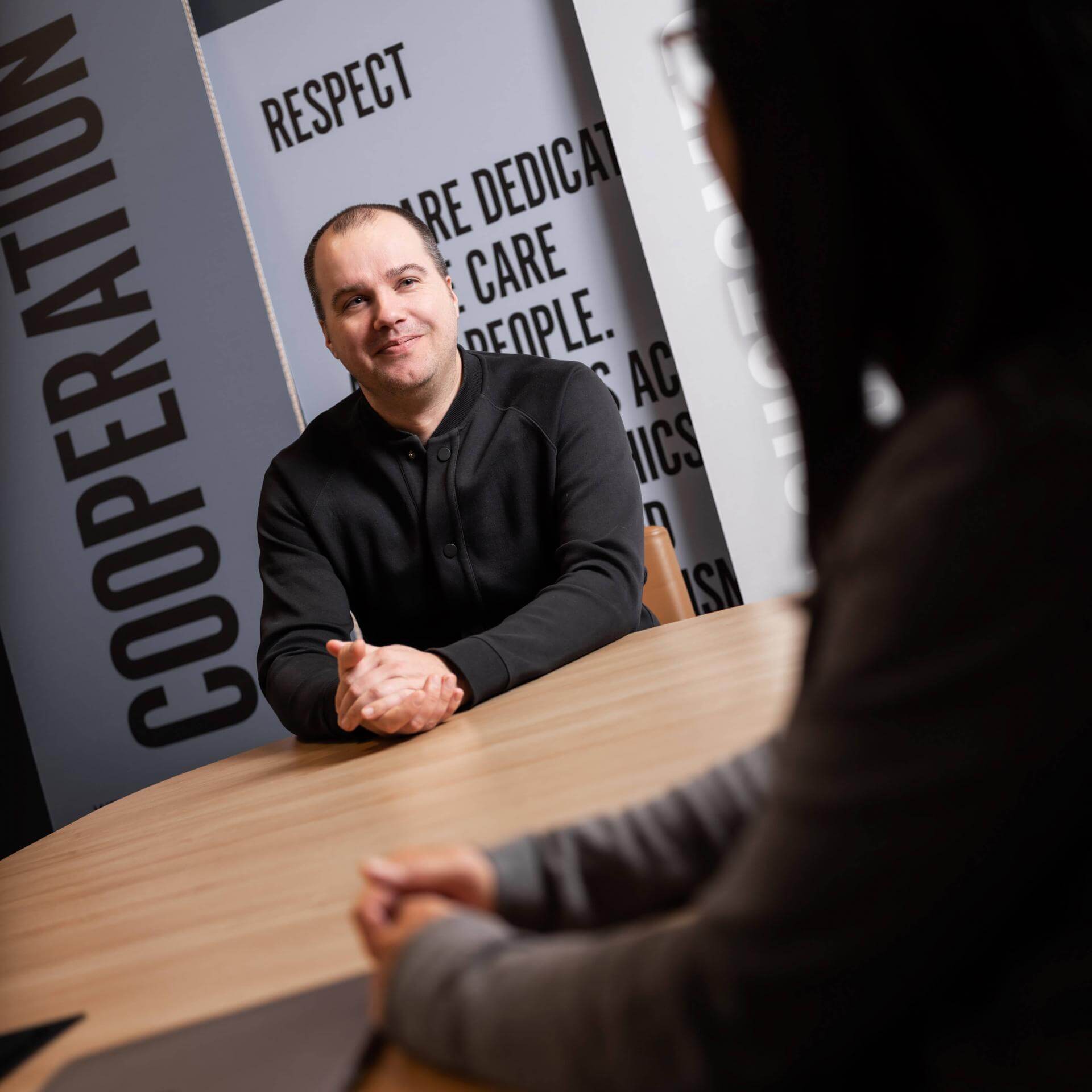 Two persons meeting in a conference room.