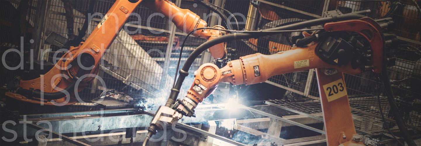 Industrial robots welding surrounded by mesh panels of Troax machine guarding.