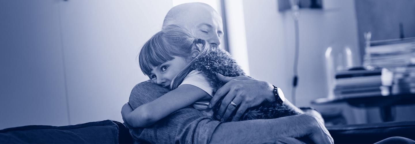 Dad and daughter hugging each other.