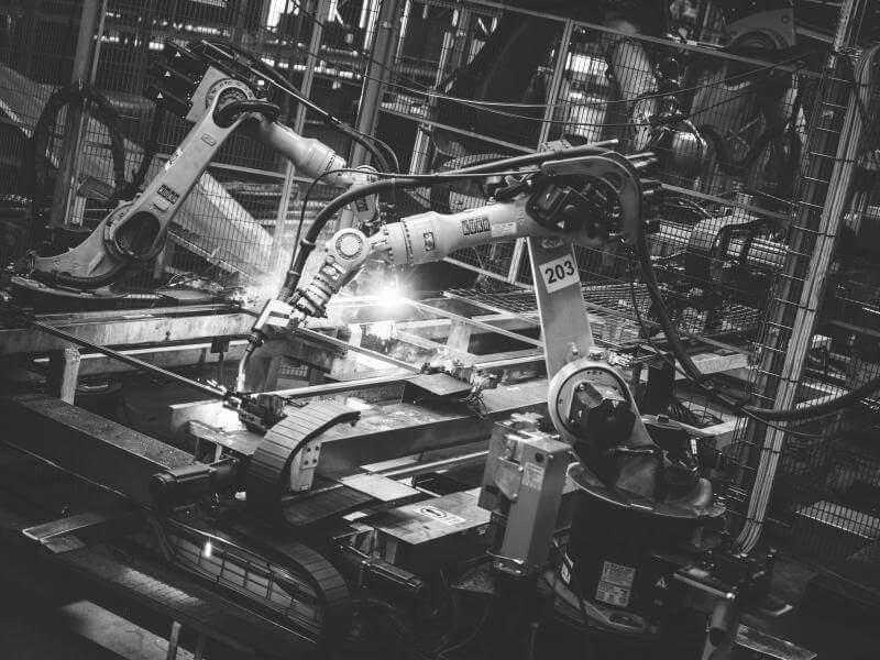 Robots welding shielded by a Troax machine guarding.