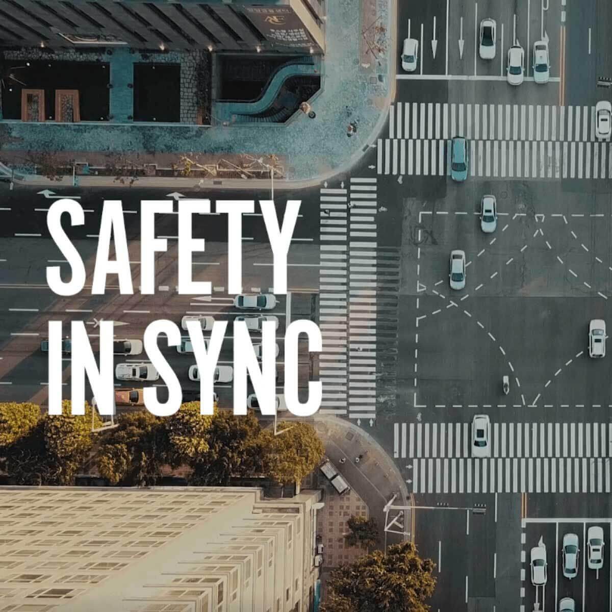 Birds eye view of a crossroads in a city environment, safety in sync